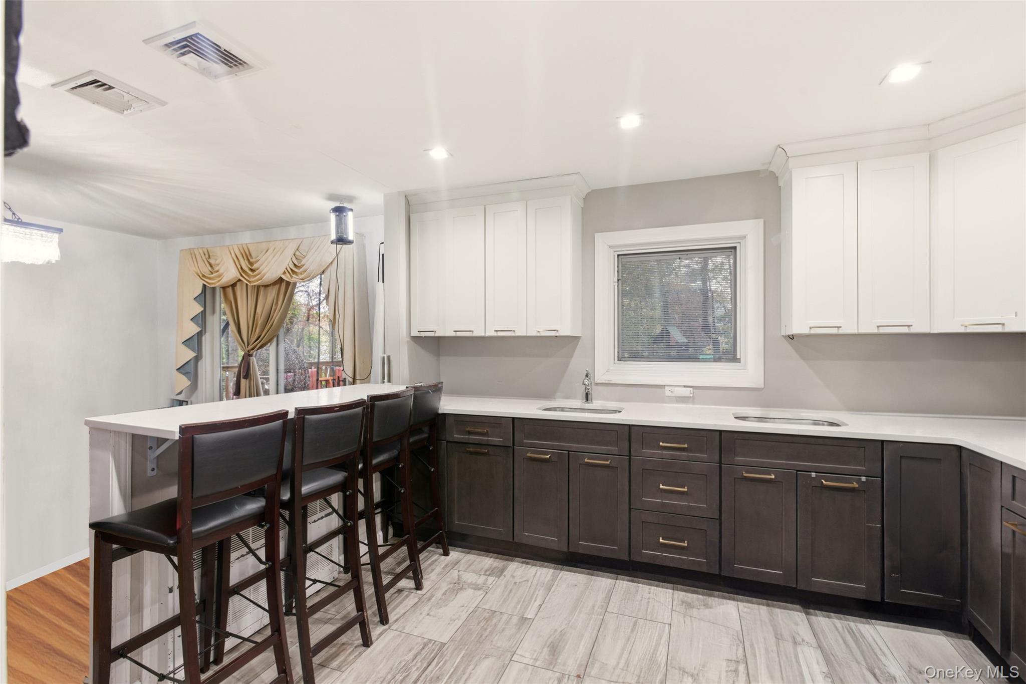 7 Jacqueline Road Monsey, NY 10952 - Photo 2 of 19 a kitchen with a sink a window and wooden cabinets