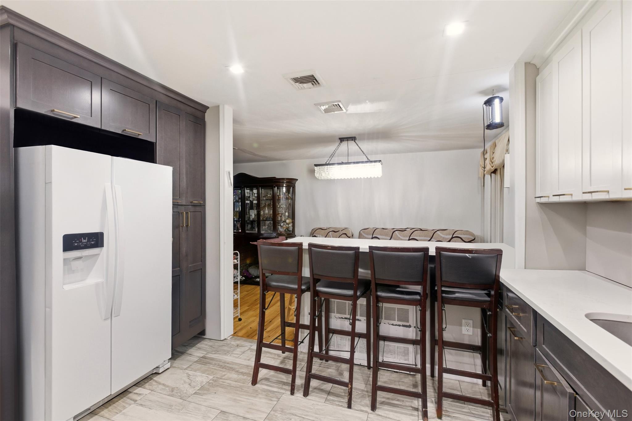 7 Jacqueline Road Monsey, NY 10952 - Photo 5 of 19 a kitchen with stainless steel appliances a table chairs and a refrigerator