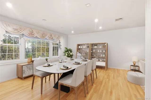 a view of a dining room with furniture window and wooden floor