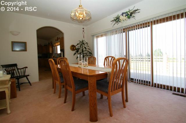 8020 Poco Road Colorado Springs, CO 80908 - Photo 5 of 25 Formal Dining Area Walks Out to Deck for Outdoor Living and Entertaining