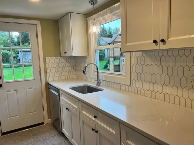 a kitchen with a sink and a window