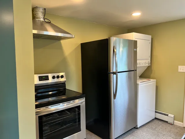 a kitchen with a refrigerator and a stove
