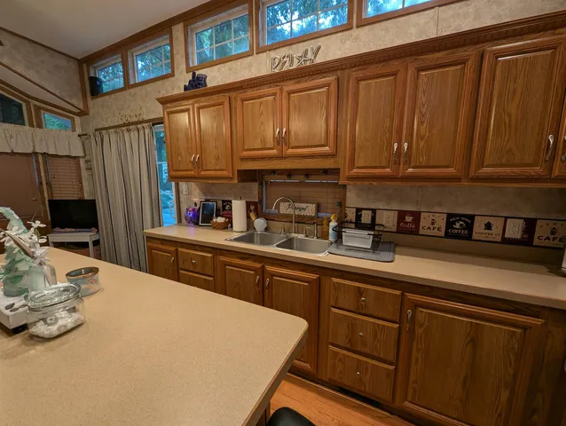 a kitchen with stainless steel appliances granite countertop a sink dishwasher stove and cabinets