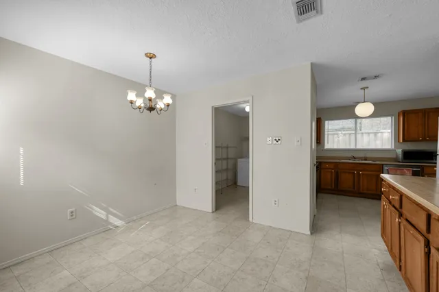 a view of a kitchen with a sink cabinets and wooden floor