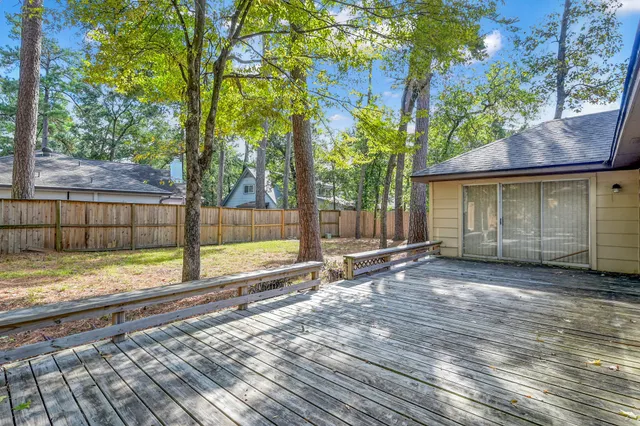 a view of a house with a yard and wooden fence