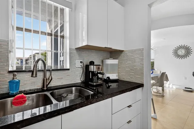 a kitchen with a sink and cabinets