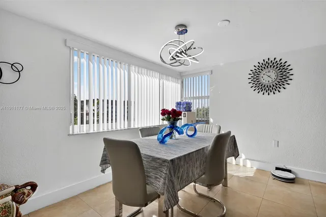 a view of a dining room with furniture wooden floor and a chandelier