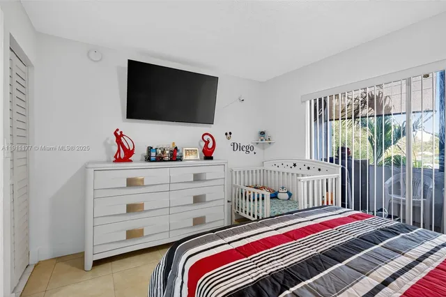 a bedroom with a bed and flat screen tv