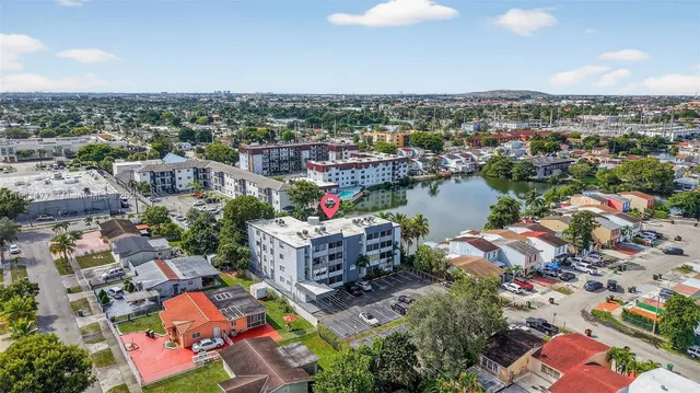 an aerial view of a city with lots of residential buildings and mountain view in back