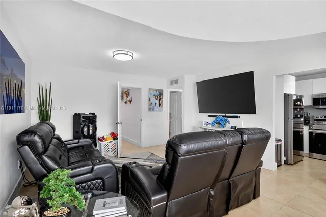 a work room with furniture and a flat screen tv
