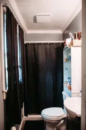 a bathroom with a sink a toilet a shower and a mirror