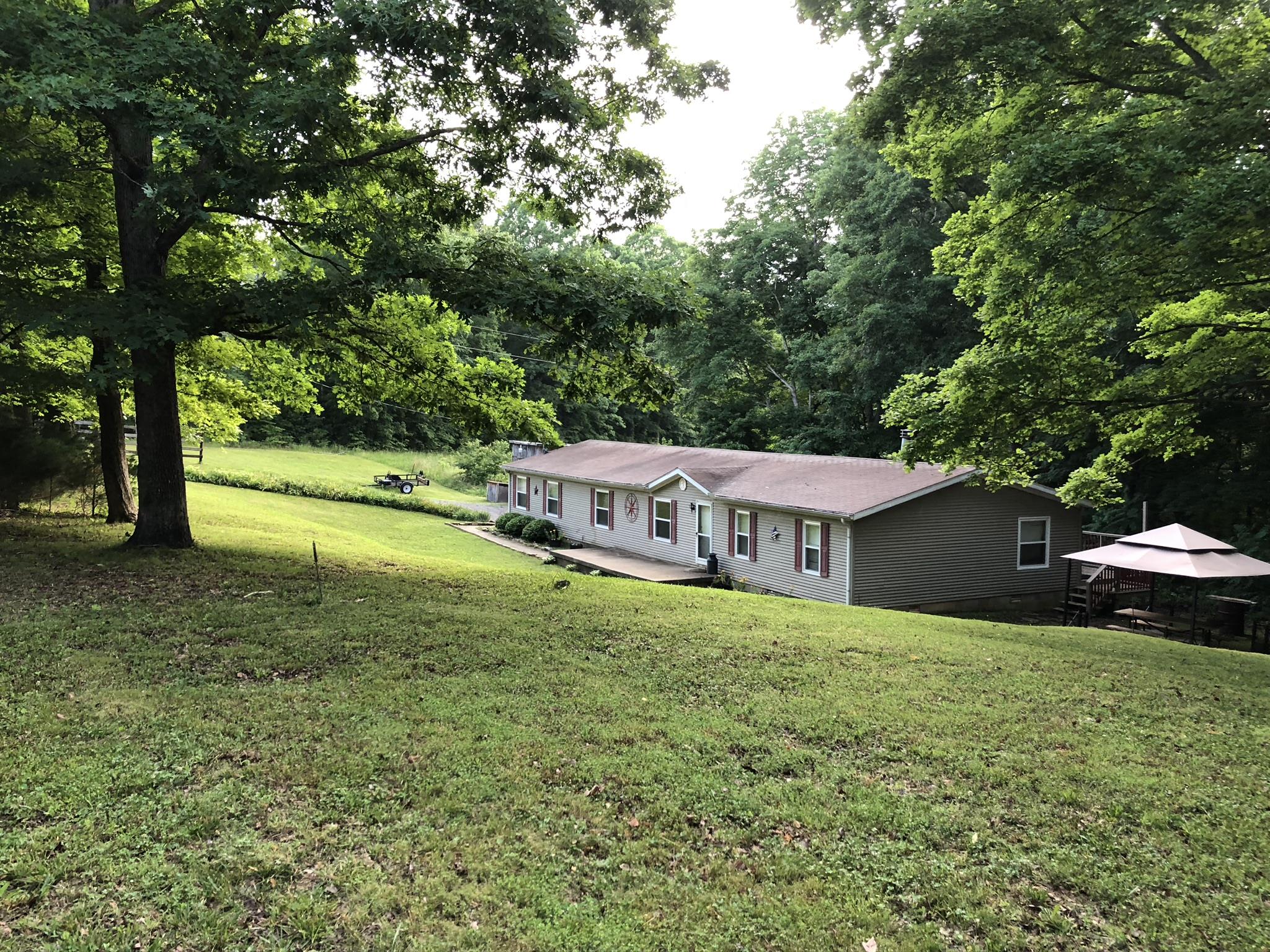 399 Brock Road Charlotte, TN 37036 - Photo 16 of 22 Nice lawn with mature trees everywhere.