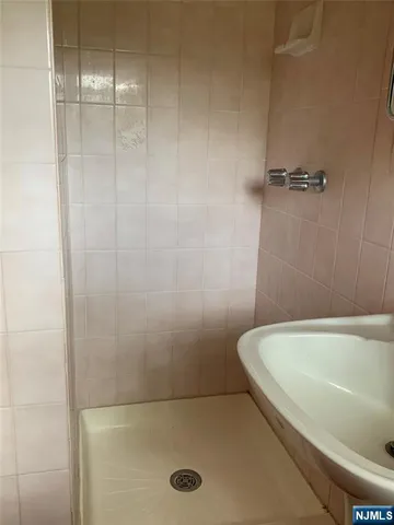 a bathroom with a tub and a shower