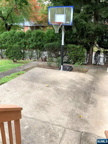 a front view of a house with a yard and tree s