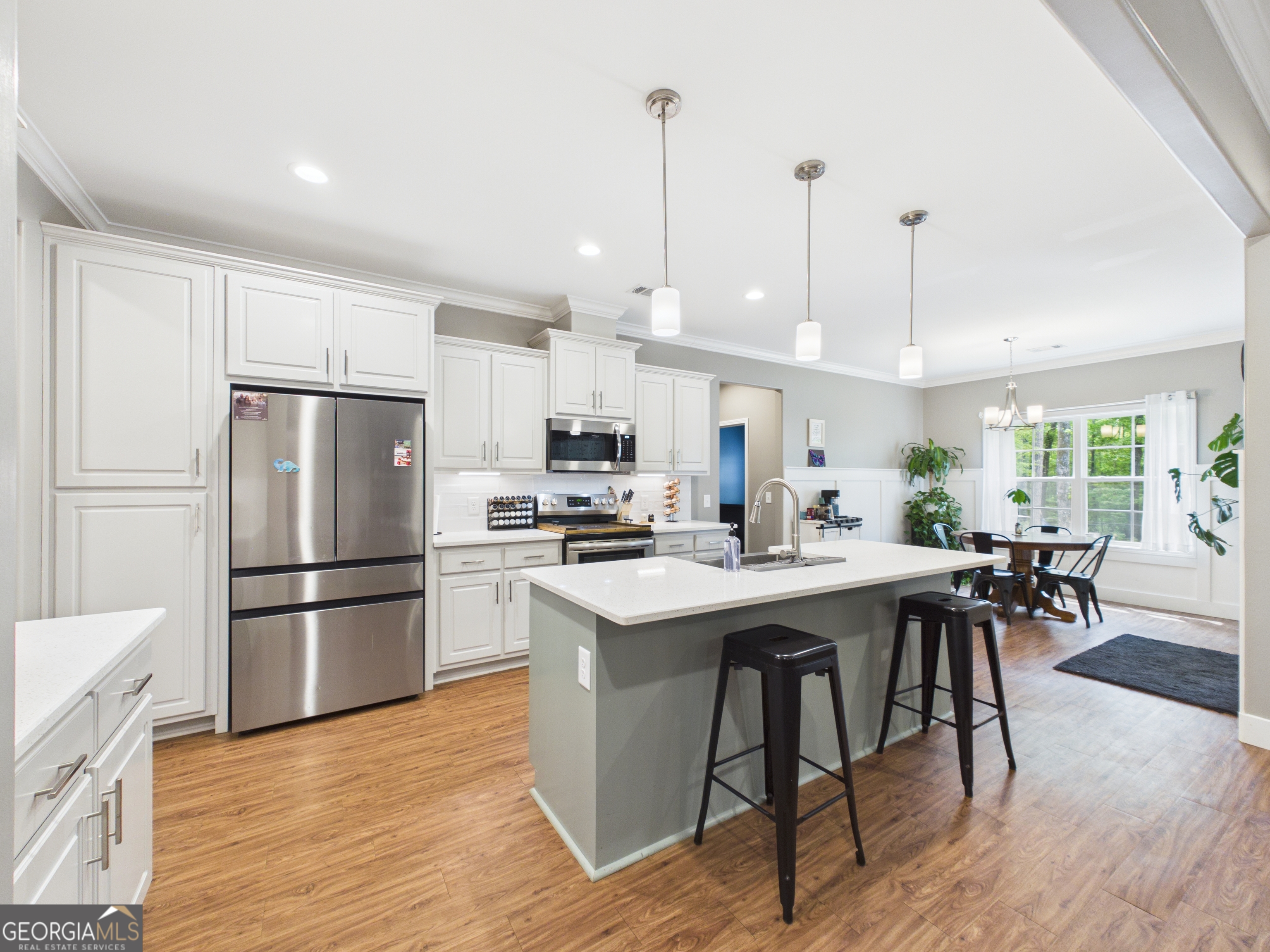 143 Terry Lane Fortson, GA 31808 - Photo 12 of 46 a kitchen with stainless steel appliances a stove a sink a refrigerator a table and chairs