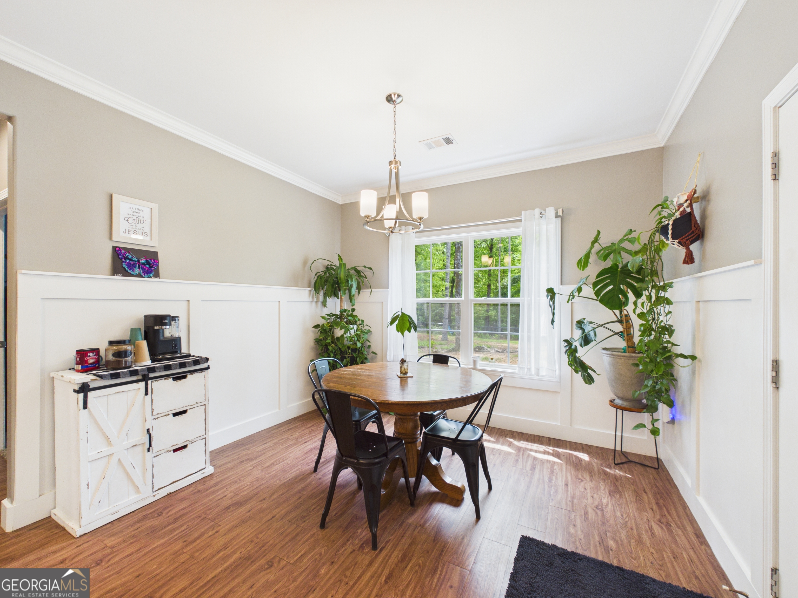 143 Terry Lane Fortson, GA 31808 - Photo 15 of 46 a dining room with furniture potted plants and wooden floor