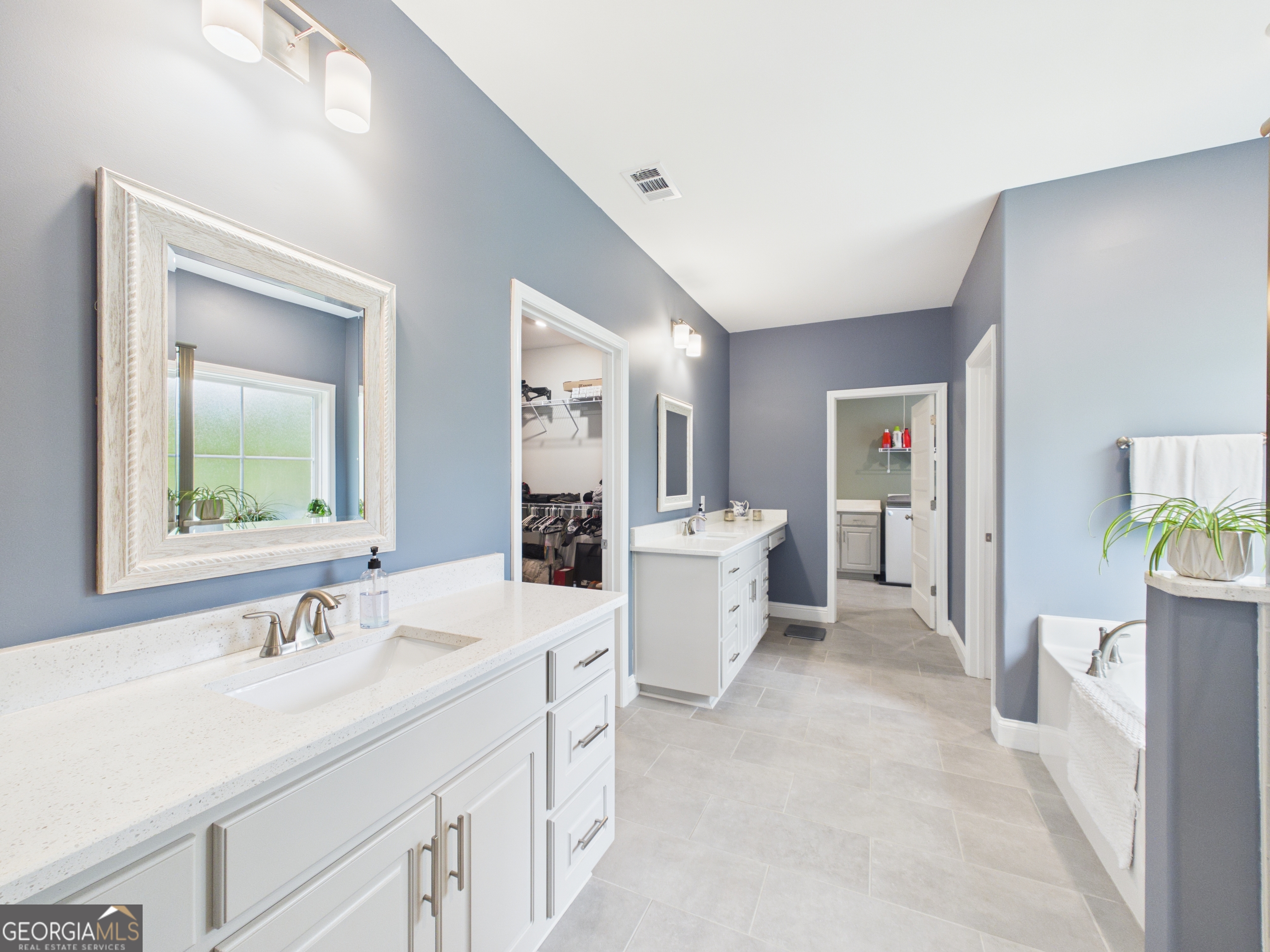 143 Terry Lane Fortson, GA 31808 - Photo 19 of 46 a spacious bathroom with a double vanity sink a mirror and a bathtub