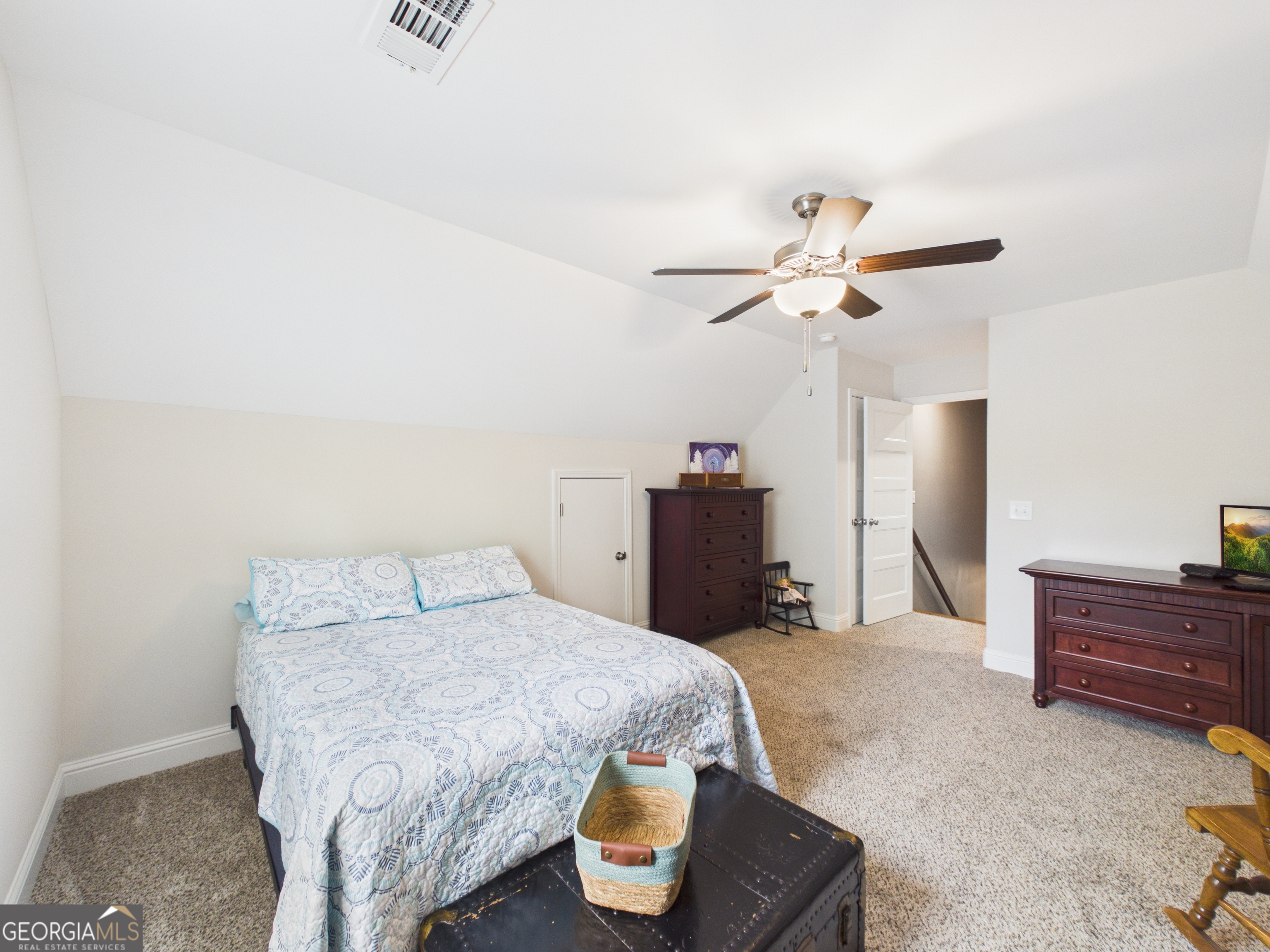 143 Terry Lane Fortson, GA 31808 - Photo 27 of 46 a bedroom with a bed and a chandelier