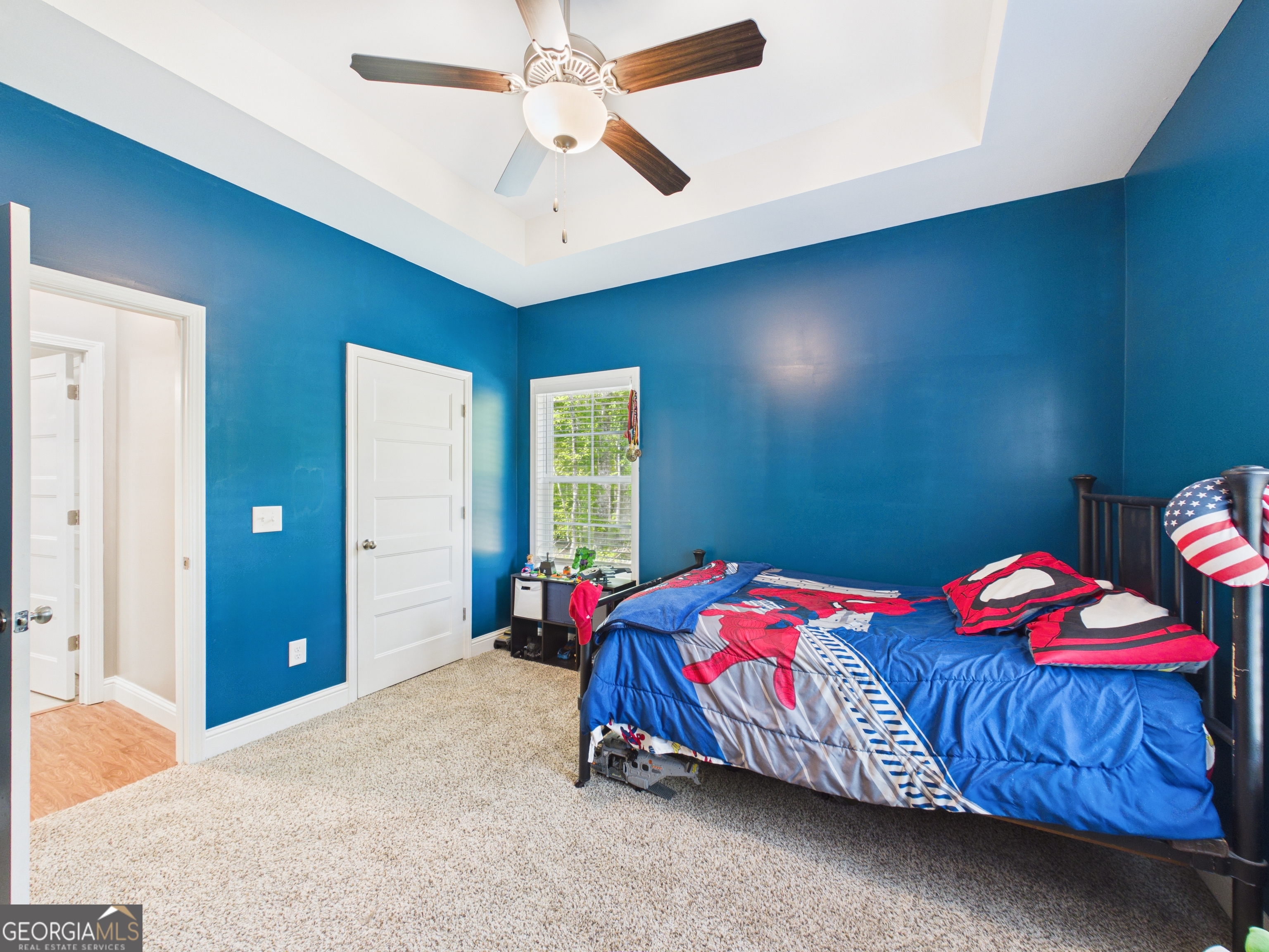 143 Terry Lane Fortson, GA 31808 - Photo 36 of 46 a bedroom with a bed and a chandelier