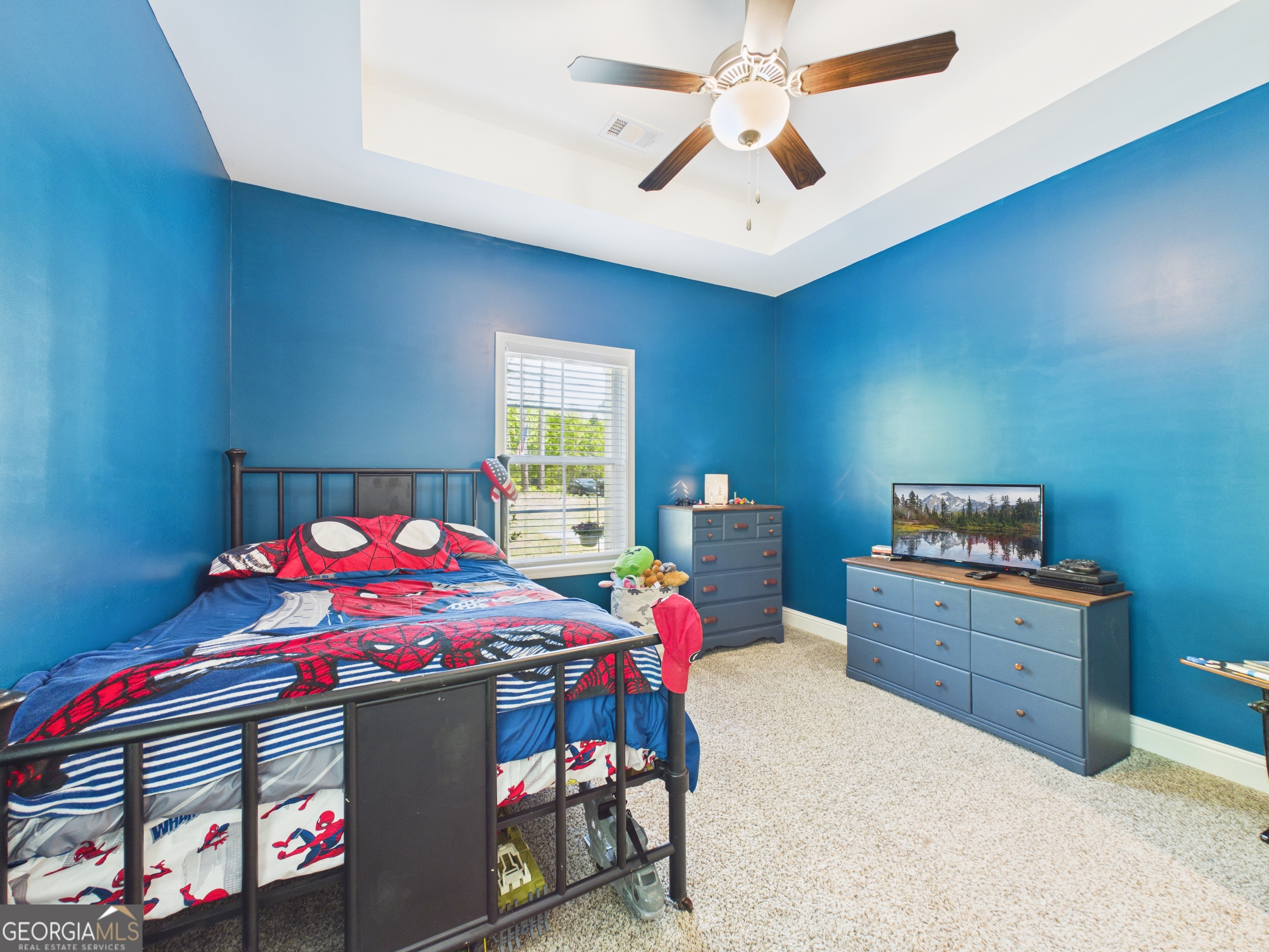 143 Terry Lane Fortson, GA 31808 - Photo 38 of 46 a bedroom with a bed and a chandelier