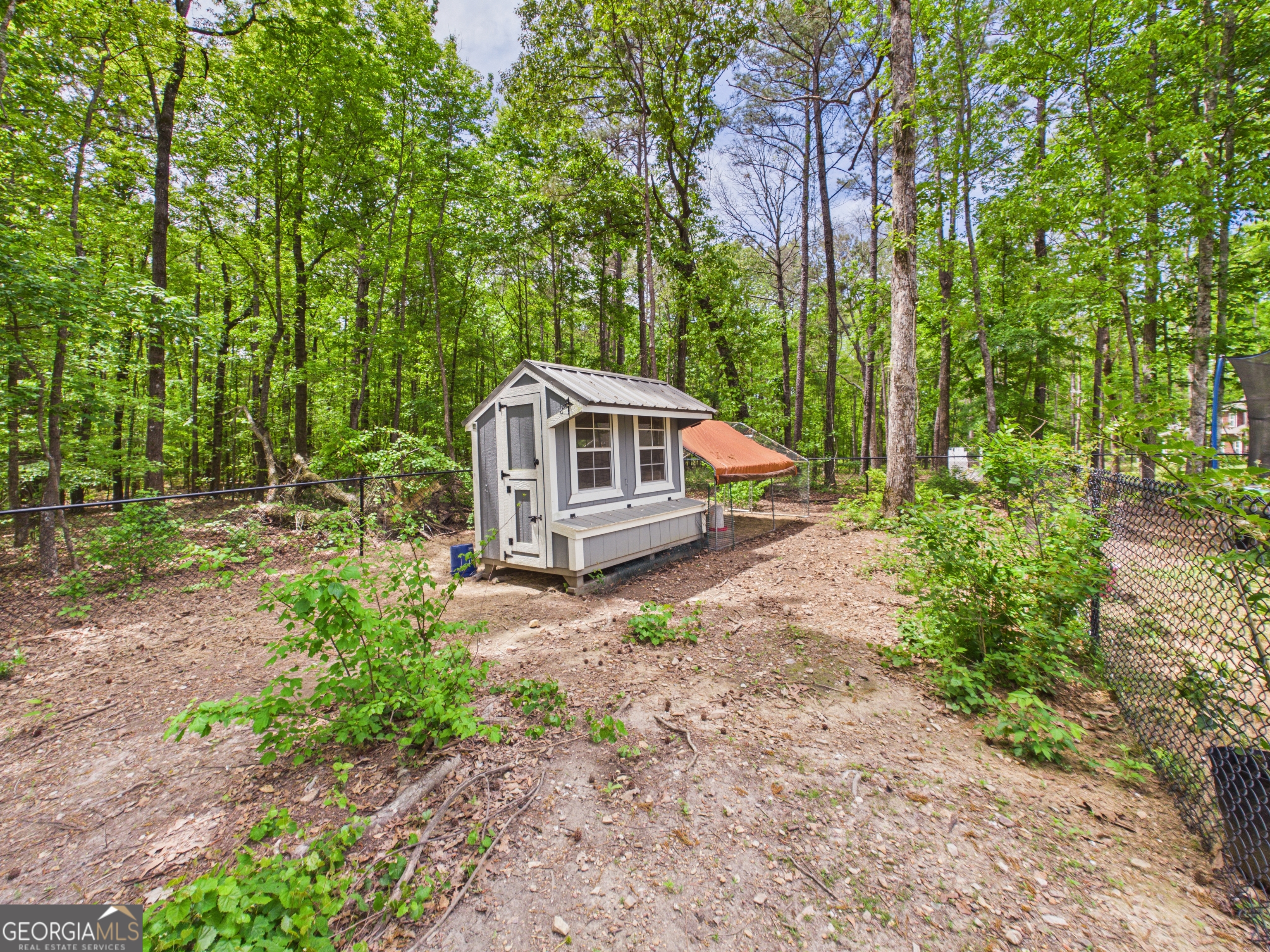 143 Terry Lane Fortson, GA 31808 - Photo 41 of 46 a house with tall trees in the background