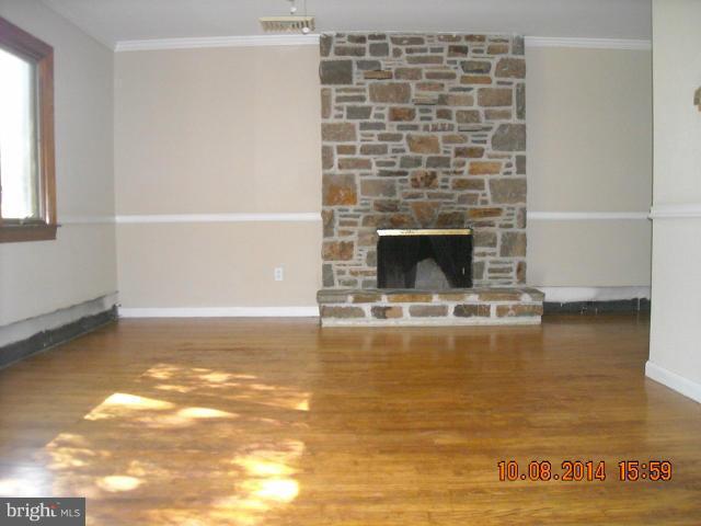 442 West Maple Road Linthicum Heights, MD 21090 - Photo 8 of 15 a living room with a fireplace and a hard wood floor