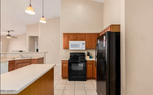 a kitchen with a refrigerator and a stove
