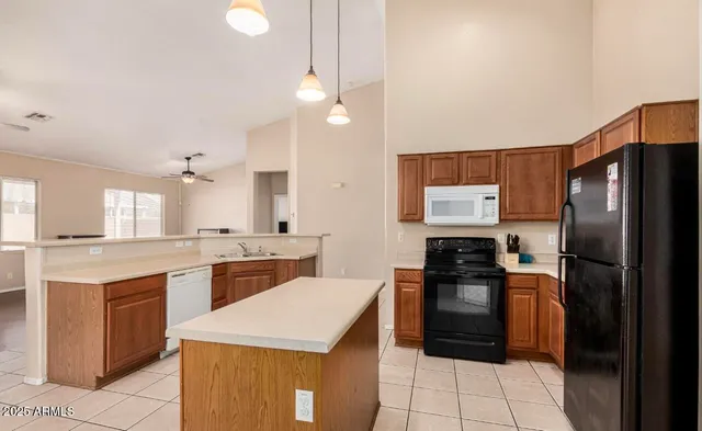 a kitchen with a sink a refrigerator and a stove