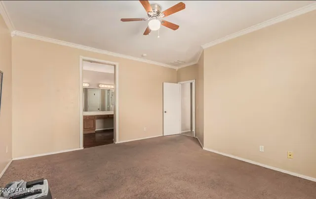 an empty room with closet and windows