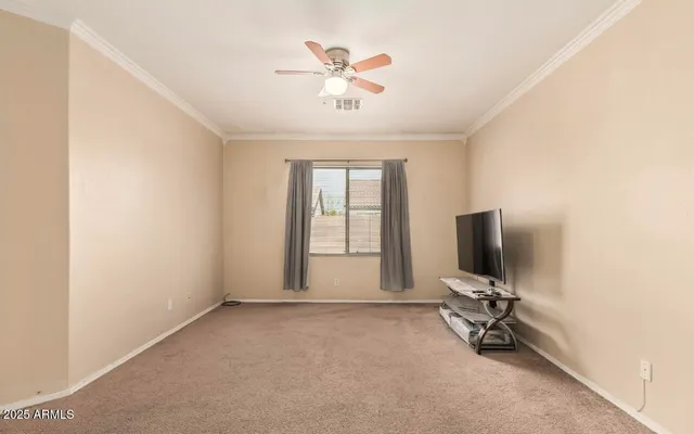 a view of a livingroom with a ceiling fan and a window