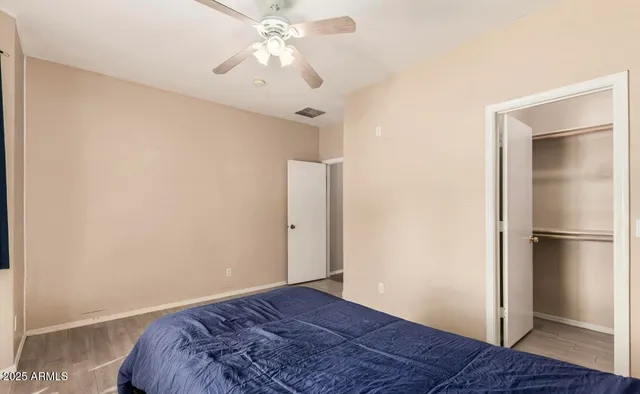 a view of a bedroom with wooden floor