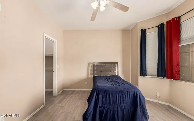 a view of bedroom with furniture and wooden floor