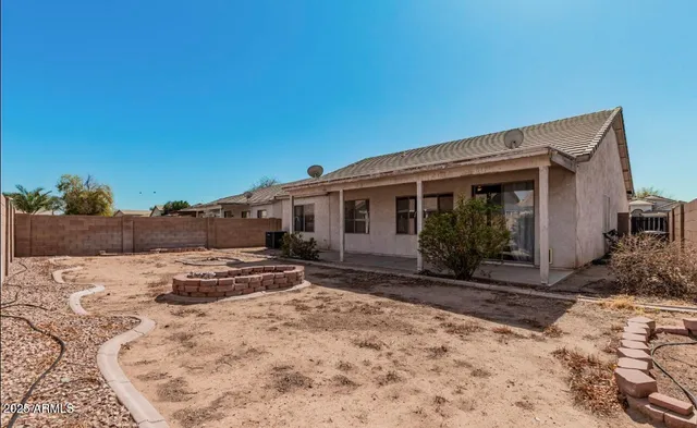 a view of a house with a yard covered in snow