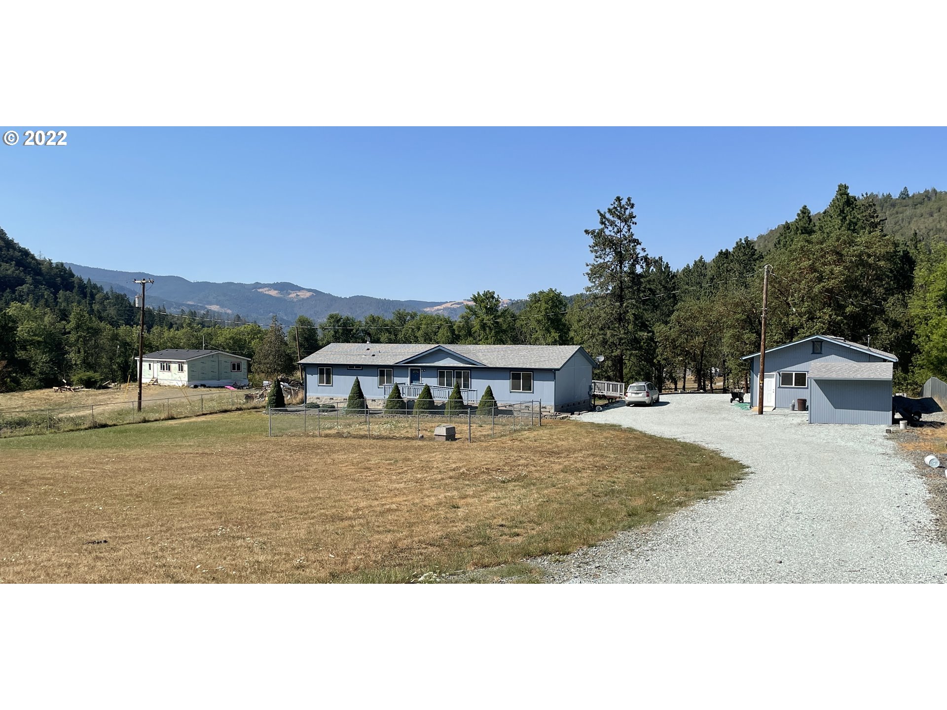 307 Evergreen Ridge Road Riddle, OR 97469 - Photo 1 of 29 a view of house with outdoor space and trees