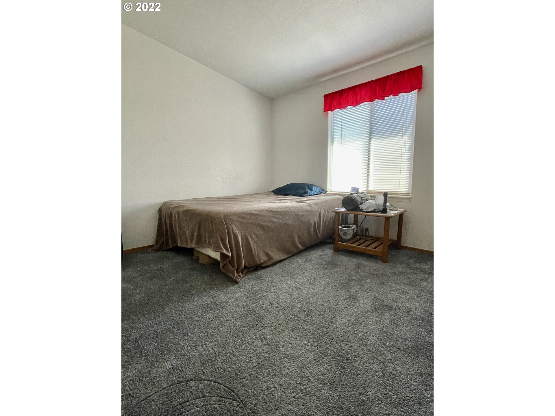 307 Evergreen Ridge Road Riddle, OR 97469 - Photo 17 of 29 a bed room with a bed and a window