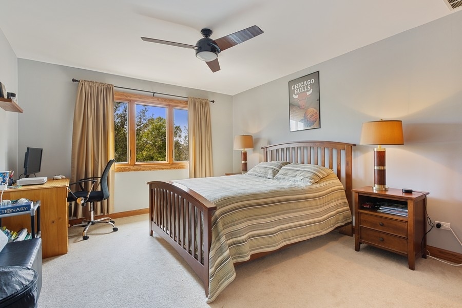 709 South Anderson Road New Lenox, IL 60451 - Photo 17 of 28 a bedroom with a bed and a chandelier