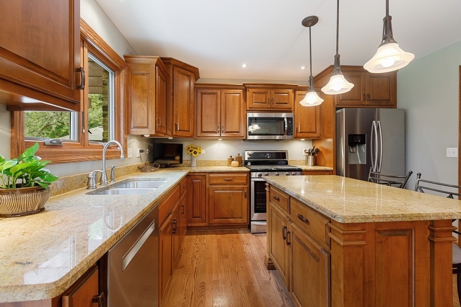 709 South Anderson Road New Lenox, IL 60451 - Photo 6 of 28 a kitchen with stainless steel appliances granite countertop a sink a stove and a wooden floors