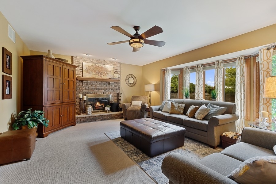 709 South Anderson Road New Lenox, IL 60451 - Photo 9 of 28 a living room with furniture ceiling fan and a large window