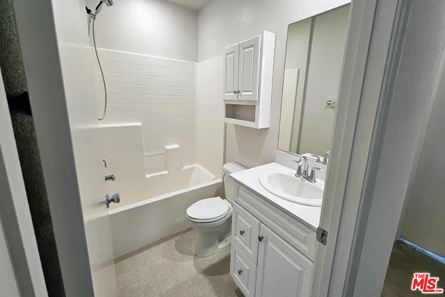 a bathroom with a sink toilet a mirror and shower
