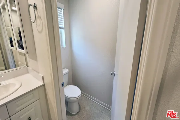 a white toilet sitting next to a bathroom sink