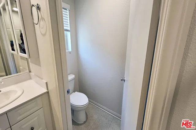 a white toilet sitting next to a bathroom sink
