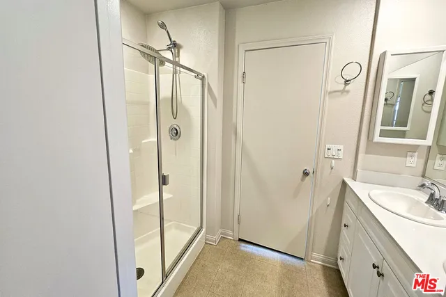 a bathroom with a shower and a sink