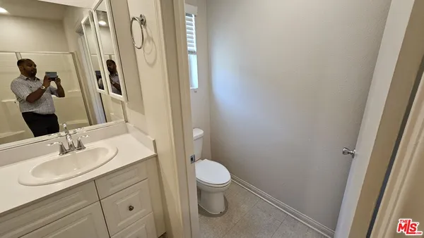 a bathroom with a sink a toilet and shower curtain