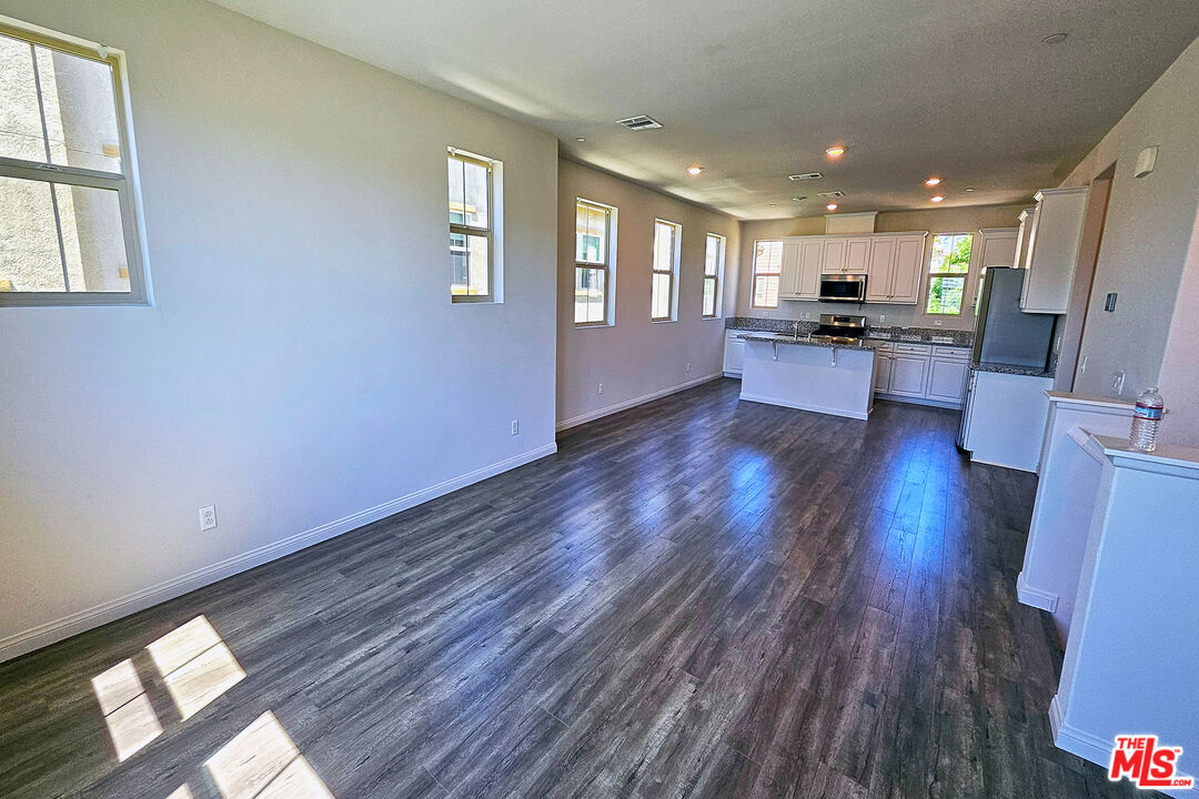 7245 Maple Road Van Nuys, CA 91405 - Photo 31 of 45 a view of kitchen with refrigerator stove and wooden floor