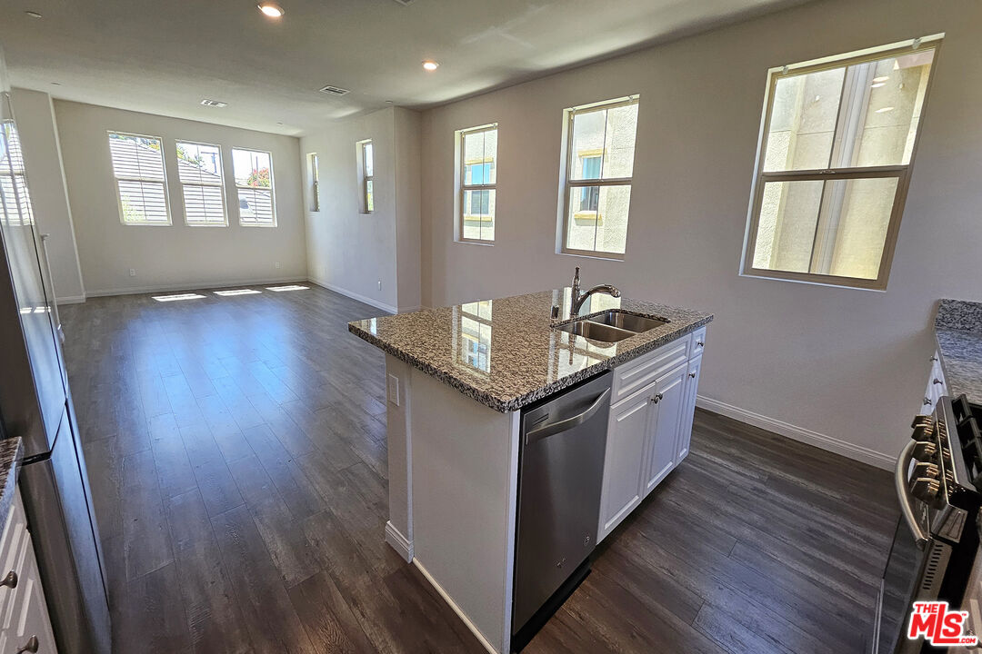 7245 Maple Road Van Nuys, CA 91405 - Photo 34 of 45 a kitchen with granite countertop a sink and wooden floor
