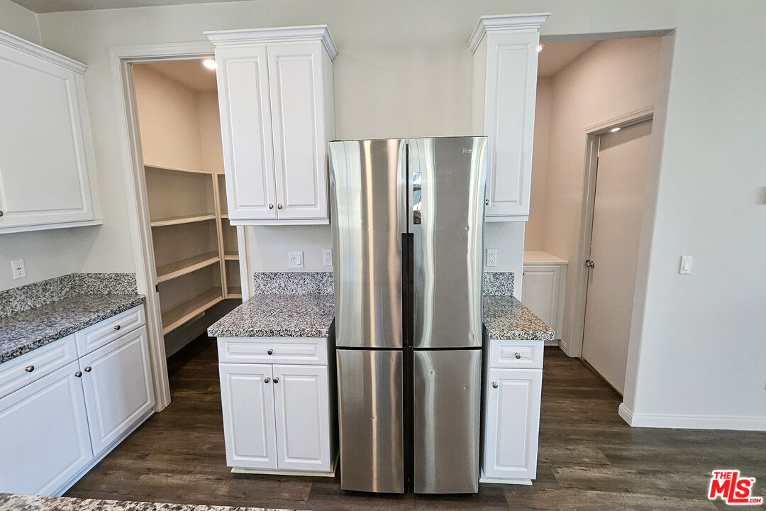 7245 Maple Road Van Nuys, CA 91405 - Photo 36 of 45 a kitchen with stainless steel appliances a refrigerator and cabinets