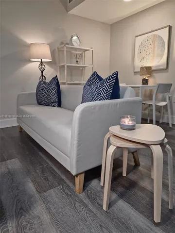 a bedroom with furniture and wooden floor