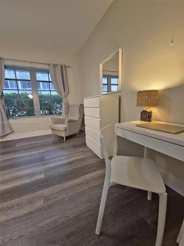 a room with a bed and wooden floor