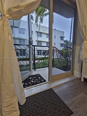 a room with lots of windows and plants