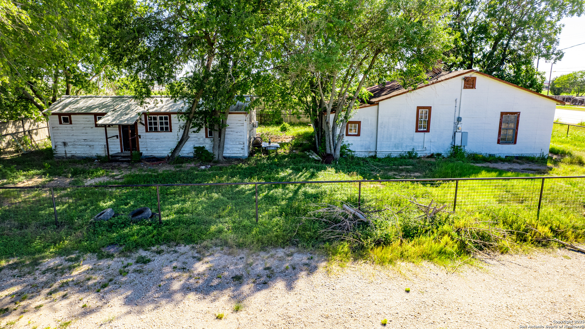 16874 Lookout Road Selma, TX 78154 - Photo 5 of 8 a view of a yard in front of a house with large trees